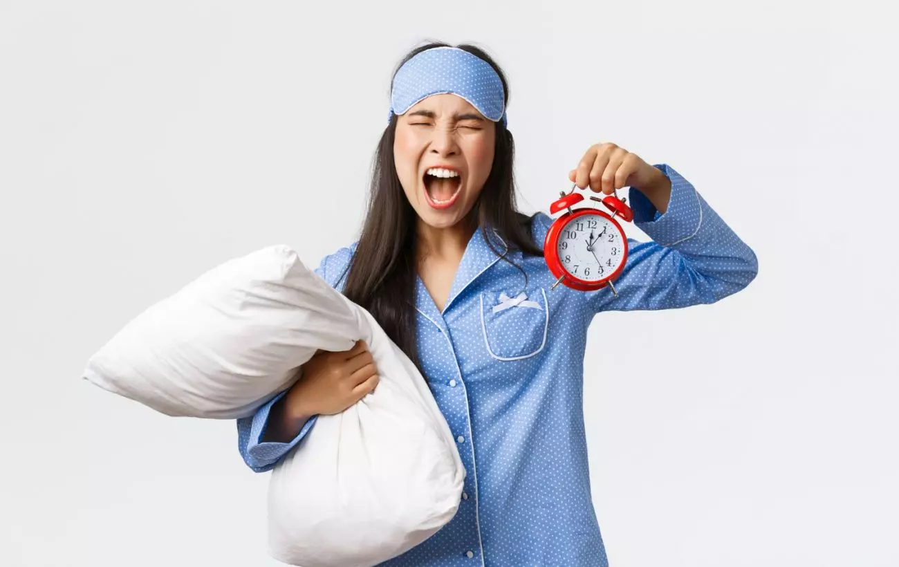 Annoyed Mad Asian Girl Blue Pajamas Sleeping Mask Screaming Frustrated As Overslept Showing Alarm Clock Shouting Bothered Being Late Work Holding Pillow